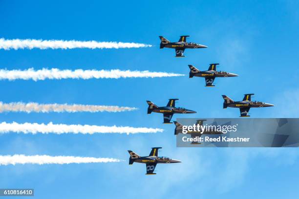the breitling l-39 jet team performs a close formation fly by for the crowd at an air show. - espectáculo aéreo fotografías e imágenes de stock