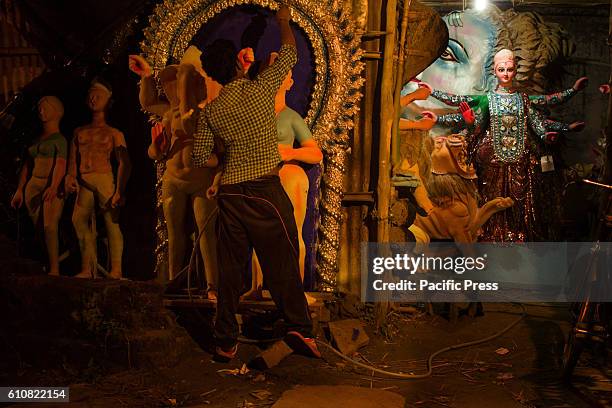 Boy painting idols .With Durga Puja round the corner, preparations are in full swing.Durga Puja is the most important festival of Hindus. Bengal...