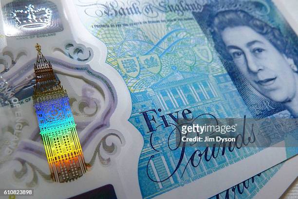 Photo illustration of the new British five pound note, featuring security features which include a see-through window and a foil Elizabeth Tower, on...