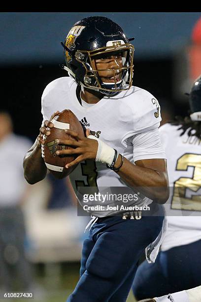 Maurice Alexander of the Florida International Golden Panthers scrambles out of the pocket with the ball against the Central Florida Knights on...