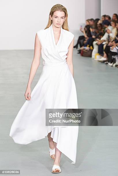 Model walks down the runway wearing Sid Neigum's spring/summer 17 collection at London Fashion Week on September 20th 2016