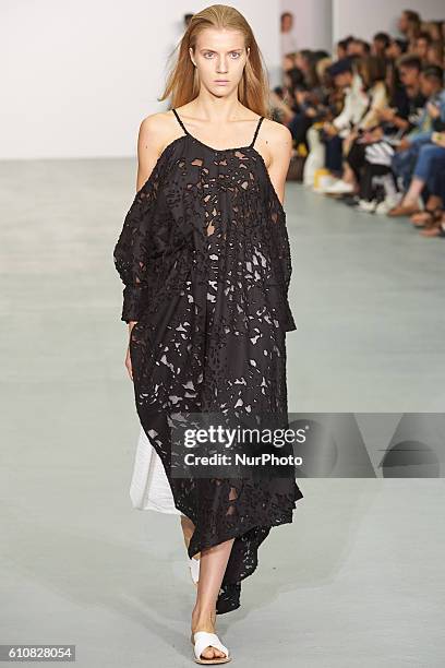 Model walks down the runway wearing Sid Neigum's spring/summer 17 collection at London Fashion Week on September 20th 2016