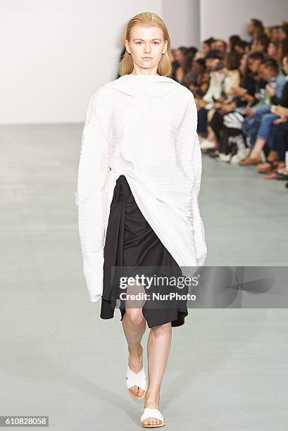 Model walks down the runway wearing Sid Neigum's spring/summer 17 collection at London Fashion Week on September 20th 2016