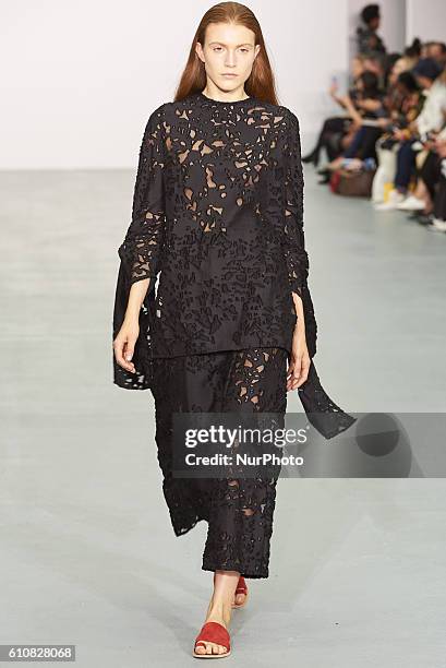 Model walks down the runway wearing Sid Neigum's spring/summer 17 collection at London Fashion Week on September 20th 2016