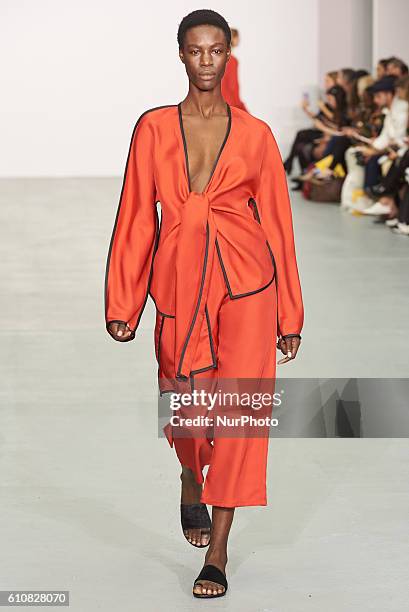 Model walks down the runway wearing Sid Neigum's spring/summer 17 collection at London Fashion Week on September 20th 2016