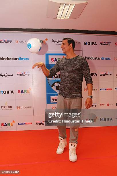Bollywood actor Akshay Kumar poses with football during the grand opening ceremony of HT GIFA-2016 at Thyagaraj Stadium, on September 24, 2016 in New...