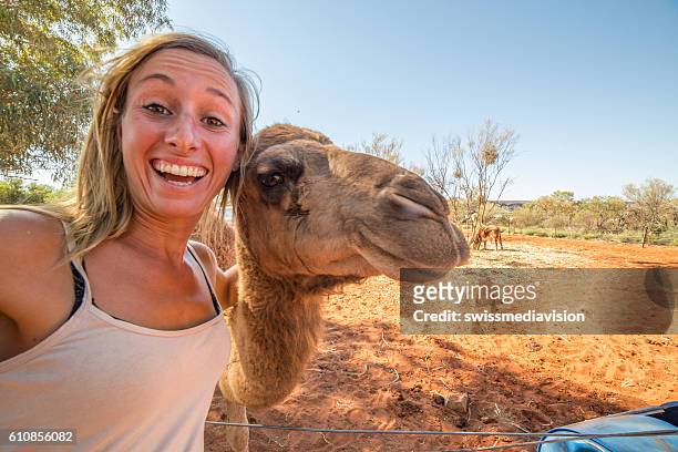 young woman in australia takes selfie portrait with camel - animal selfies stock pictures, royalty-free photos & images