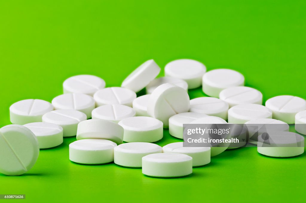 Heap of white round pills