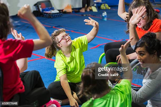 teenage girl with down syndrome in exercise class - physical education stock pictures, royalty-free photos & images