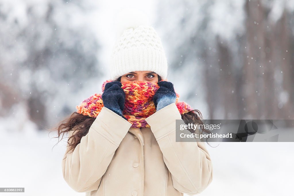 Young woman freezing fun in the snow forest