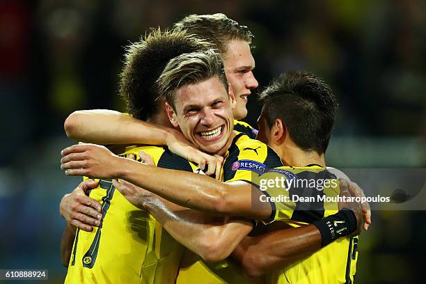 Pierre-Emerick Aubameyang of Borussia Dortmund celebrates with team mates including Lukasz Piszczek as he scores their first goal during the UEFA...