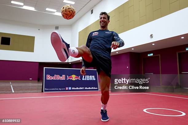 Daniel Ricciardo of Australia and Red Bull Racing plays Malaysian sport sepak takraw at the iM4U Sentral in Puchong during previews for the Malaysia...