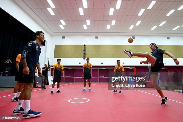 Daniel Ricciardo of Australia and Red Bull Racing and Max Verstappen of Netherlands and Red Bull Racing play Malaysian sport sepak takraw at the iM4U...