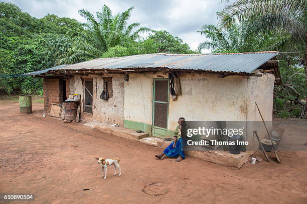 Congo, Ghana An old woman is sitting in front of a house on a cashew farm in Congo on September 06, 2016 in Congo, Ghana.