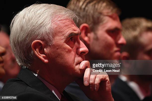 Shadow Chancellor of the Exchequer John McDonnell watches as Labour Leader Jeremy Corbyn addresses delegates and members during his keynote speech at...