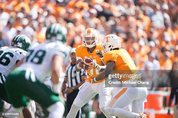Quarterback Joshua Dobbs of the Tennessee Volunteers looks to hand the ball off to running back Jalen Hurd of the Tennessee Volunteers during their...