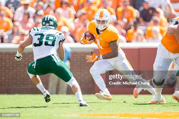 Running back Jalen Hurd of the Tennessee Volunteers looks to maneuver by linebacker Chad Moore of the Ohio Bobcats at Neyland Stadium on September...