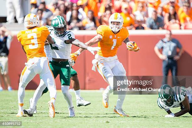 Running back Jalen Hurd of the Tennessee Volunteers looks to maneuver by safety Mayne Williams of the Ohio Bobcats at Neyland Stadium on September...