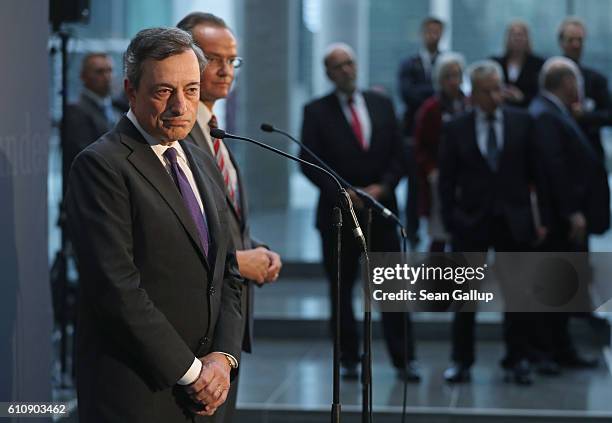 European Central Bank President Mario Draghi speaks to the media after he attended a session of the Bundestag Europe Commission on September 28, 2016...