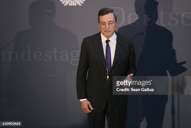 European Central Bank President Mario Draghi speaks to the media after he attended a session of the Bundestag Europe Commission on September 28, 2016...