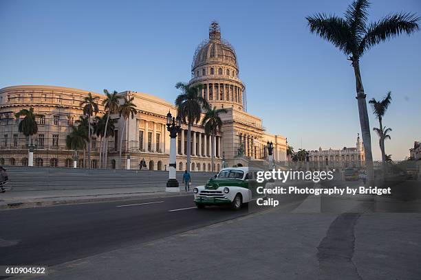 the capitol of havana at dawn - motorradpolizist stock-fotos und bilder