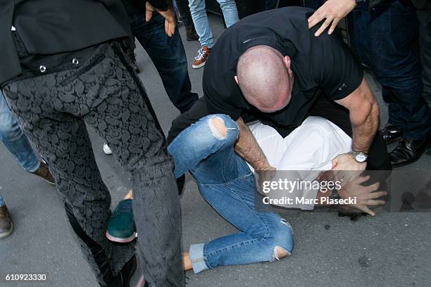 Bodyguard Pascal Duvier immobilizes Vitalii Sediuk after jumping on Kim Kardashian West at 'L'Avenue' restaurant on September 28, 2016 in Paris,...