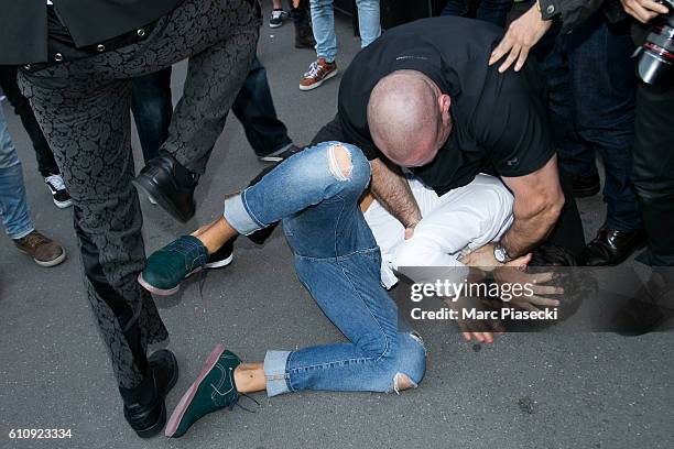 Bodyguard Pascal Duvier immobilizes Vitalii Sediuk after jumping on Kim Kardashian West at 'L'Avenue' restaurant on September 28, 2016 in Paris,...