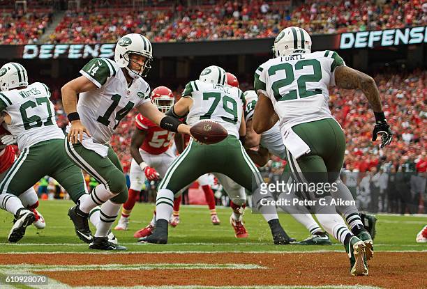 Quarterback Ryan Fitzpatrick of the New York Jets hands the ball off to running back Matt Forte against the Kansas City Chiefs during the first half...