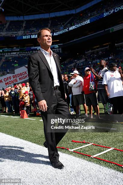 General Manager Trent Baalke of the San Francisco 49ers stands on the field prior to the game against the Seattle Seahawks at CenturyLink Field on...