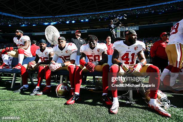NaVorro Bowman, Ahmad Brooks, Eric Reid, Eli Harold and Antoine Bethea of the San Francisco 49ers sit on the bench prior to the game against the...