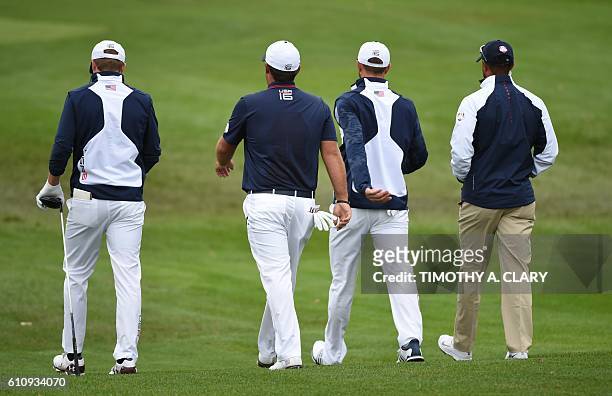 Team USA's Jordan Spieth, Patrick Reed, Dustin Johnson and vice-captain Tiger Woods during a practice round ahead of the 41st Ryder Cup at Hazeltine...