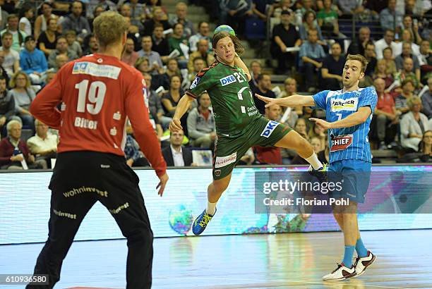 Johannes Bitter of TVB Stuttgart, Mattias Zachrisson of Fuechse Berlin and Bobby Schagen of TVB Stuttgart during the game between Fuechse Berlin and...