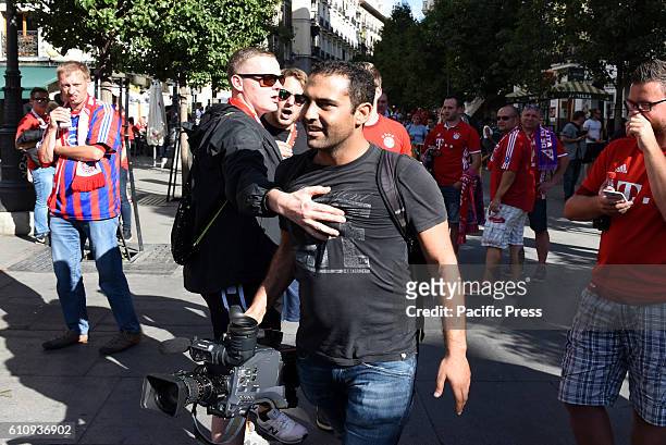 Bayern supporter stops a journalist/cameraman from filming in Madrid. Several Bayern Munich supporters have been accused of humiliating beggars at...