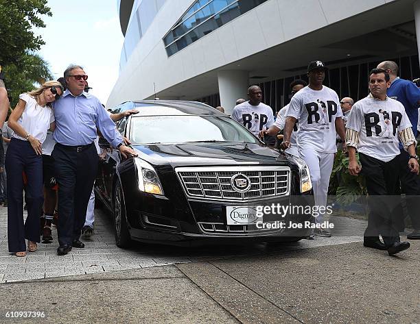 Miami Marlins owner, Jeffrey Loria and his wife Julie Loria along with players and other members of the Marlins organization and their fans walk next...