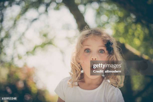 little surprised blond girl with blue eyes - erschrocken stock pictures, royalty-free photos & images