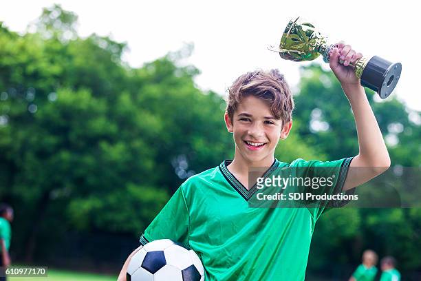 proud soccer champ with trophy - teen awards stock pictures, royalty-free photos & images