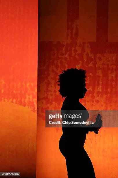 Author Chimamanda Ngozi Adichie leaves the stage following an interview during the Washington Ideas Forum at the Harman Center for the Arts September...