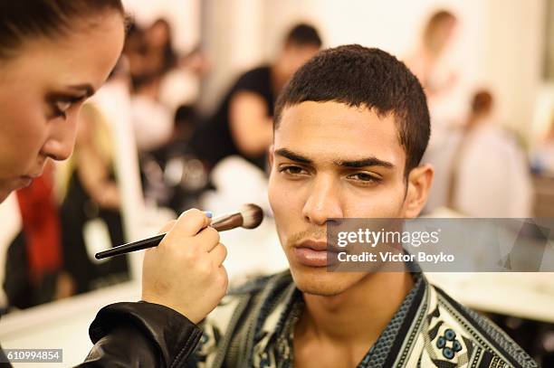 Model has makeup applied backstage during FENTY x PUMA by Rihanna at Hotel Salomon de Rothschild on September 28, 2016 in Paris, France.