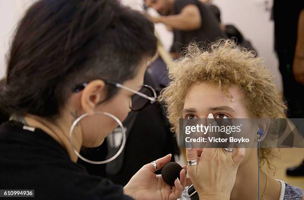 Model has makeup applied backstage during FENTY x PUMA by Rihanna at Hotel Salomon de Rothschild on September 28, 2016 in Paris, France.