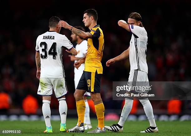 Granit Xhaka of Arsenal and Taulant Xhaka of Basel embrace at the end of the UEFA Champions League group A match between Arsenal FC and FC Basel 1893...