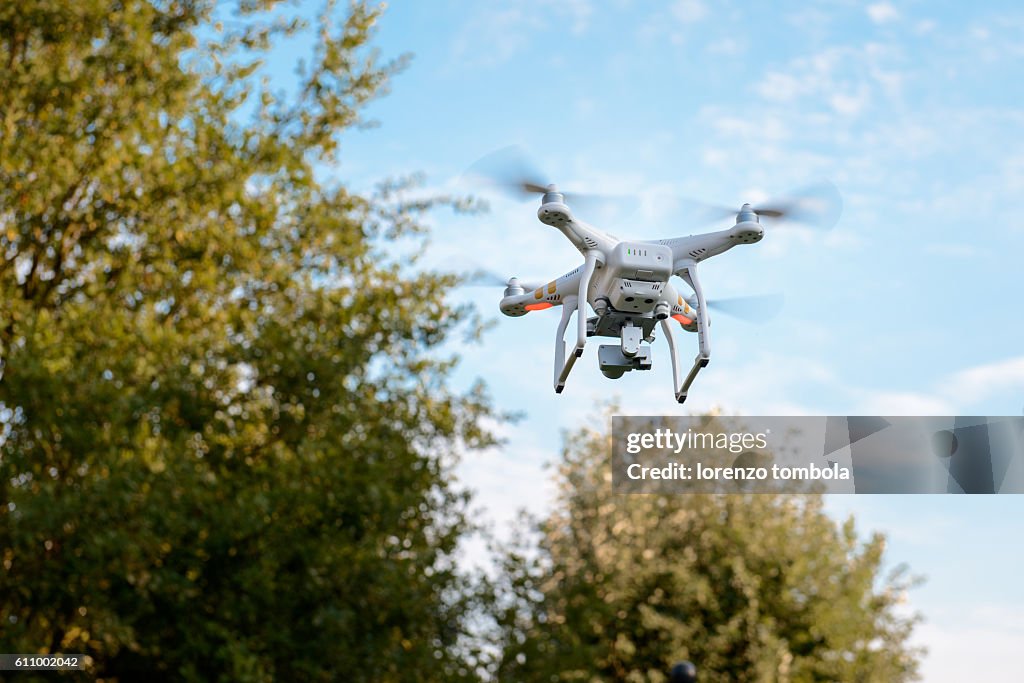 Quadcopter Drone With Camera Flying Among the Trees