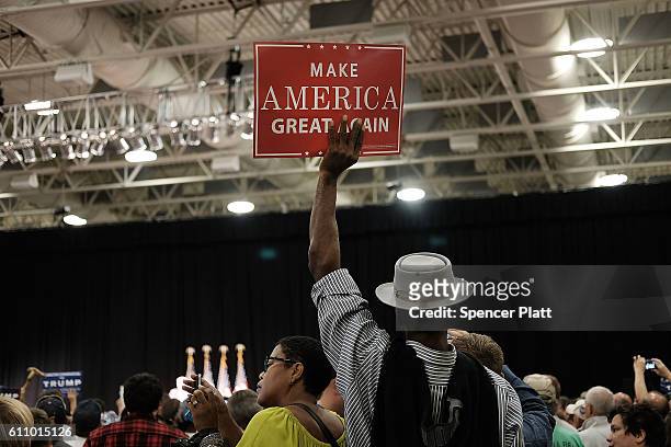 Donald Trump supporters cheer as he speak at a rally on September 28, 2016 in Council Bluffs, Iowa. Trump has been campaigning today in Iowa,...
