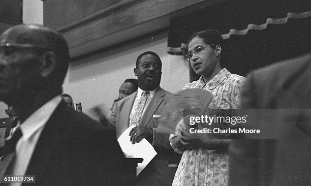 View of American Civil Rights leaders Reverend Ralph Abernathy and Rosa Parks as they stand during an unspecified event at the Holt Street Baptist...