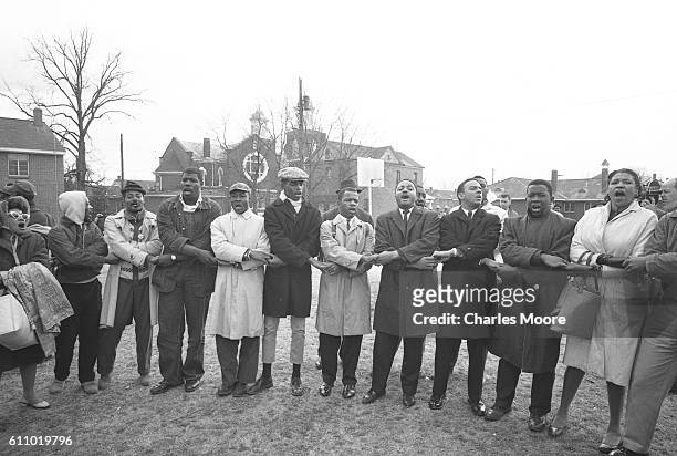 Religious and Civil Rights leaders and others hold hands in song and prayer prior to the start of the first Selma to Montgomery March, Selma,...