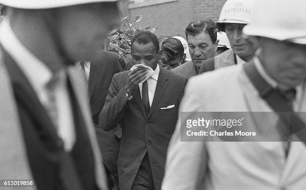 American Civil Rights activist and student James Meredith is escorted by Chief US Marshal James JP McShane an others on his way to register for...