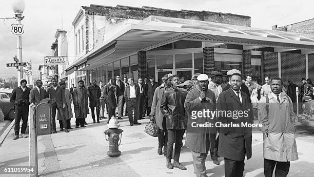 Religious and Civil Rights leaders lead others gather on Broad Street as they prepare to walk towards the Edmund Pettus Bridge during the first Selma...