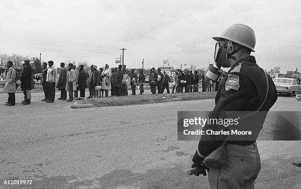 Religious and Civil Rights leaders stand at the head of the first Selma to Montgomery March after crossing the Edmund Pettus Bridge where they were...