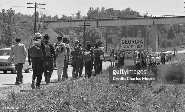 Led by Civil Rights activist Sam Shirah , marchers walk along US Route 11 and cross into Georgia past journalists and photographers, Tennessee, mid...