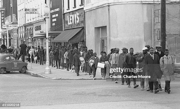 Religious and Civil Rights leaders lead others along Broad Street as they walk towards the Edmund Pettus Bridge during the first Selma to Montgomery...