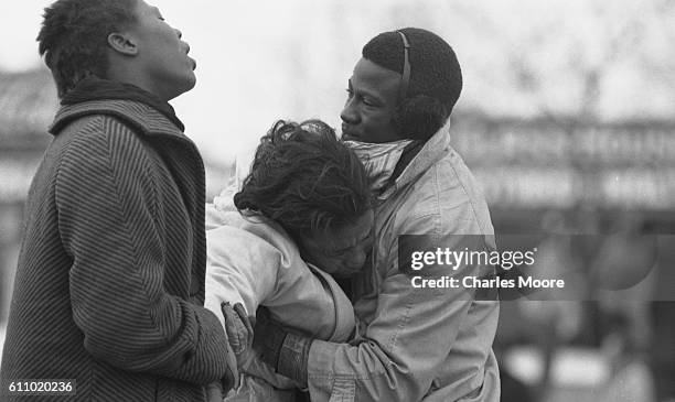 Two people lift the unconscious body of Civil Rights activist Amelia Boynton at the base of the Edmund Pettus Bridge during the first Selma to...